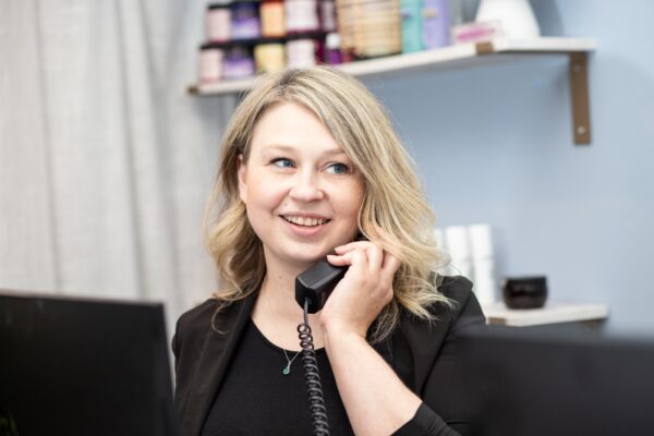 A woman answering a phone